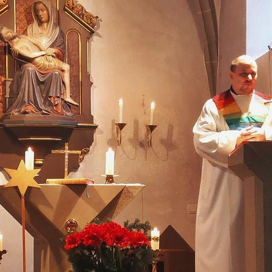 Der Pastoralreferent steht am Ambo in der Kirche.